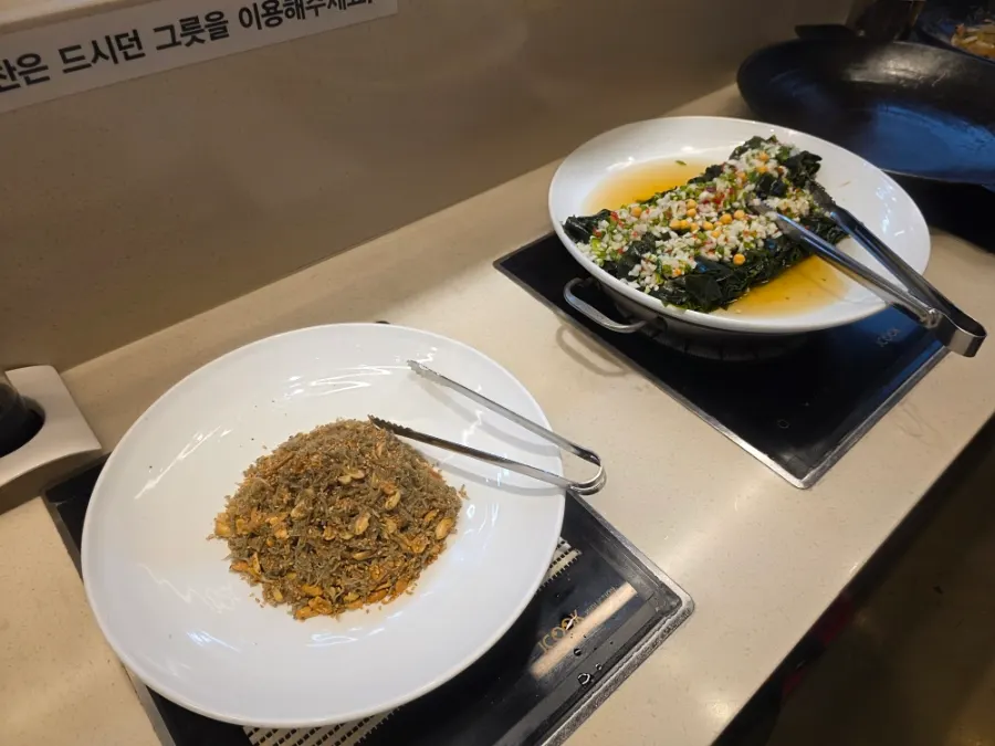 Banchan dishes laid out at the salad bar
