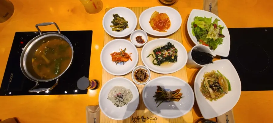 Table fully set with banchan at Geumdeungeo Deulanguil Main Branch