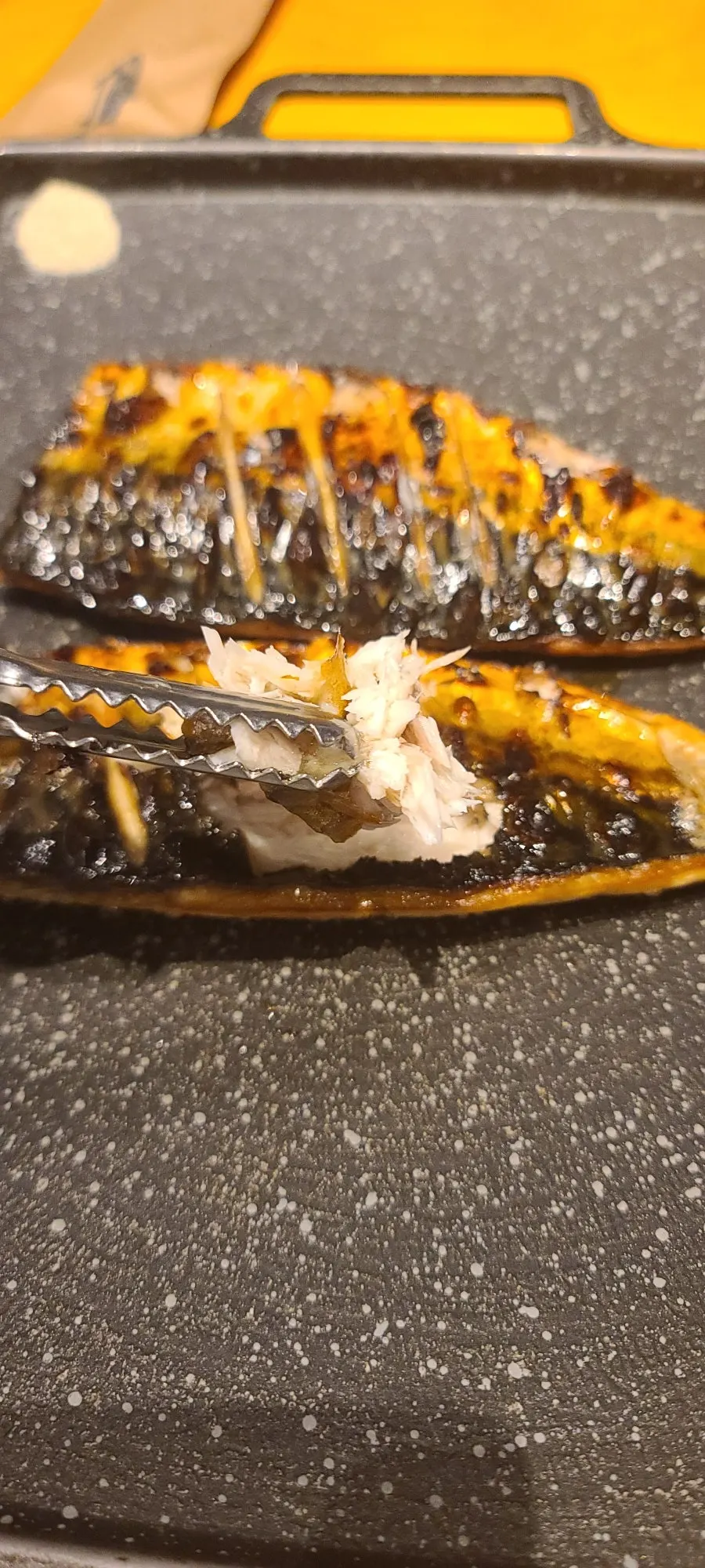 Moist mackerel flesh flaked apart on the plate