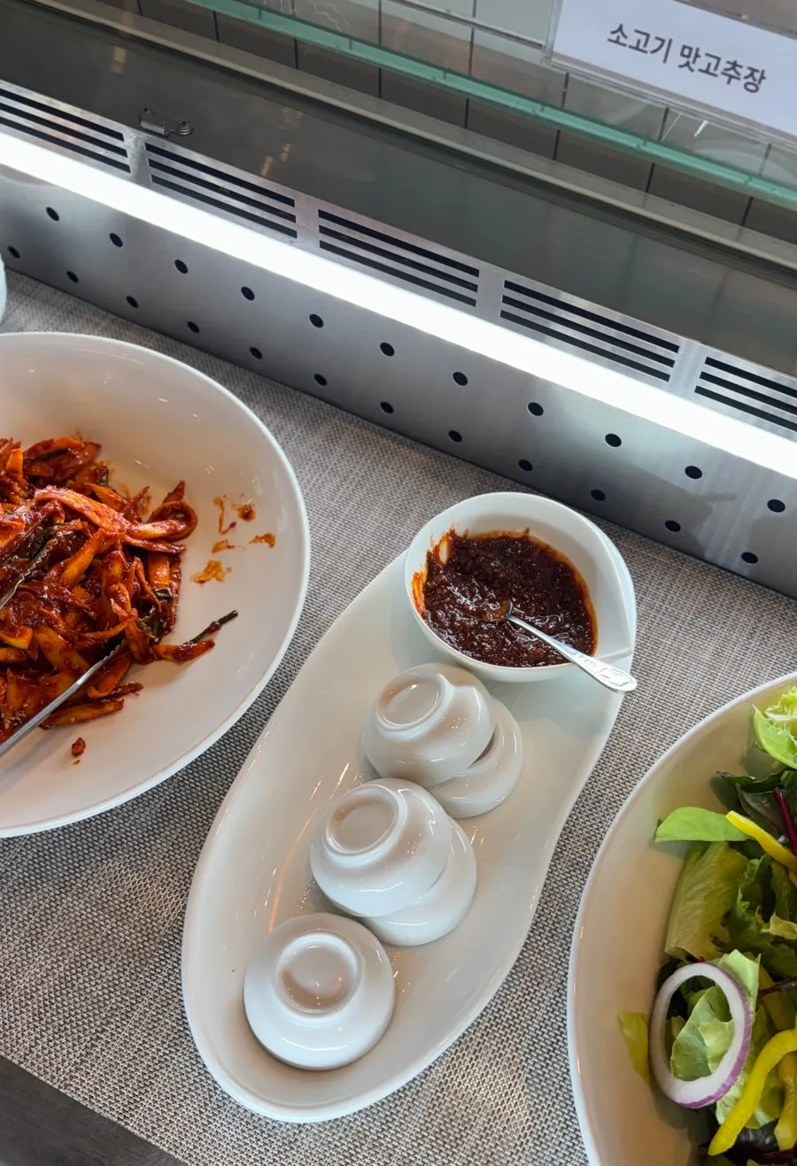 Container of seokbakji radish kimchi at the self-service bar