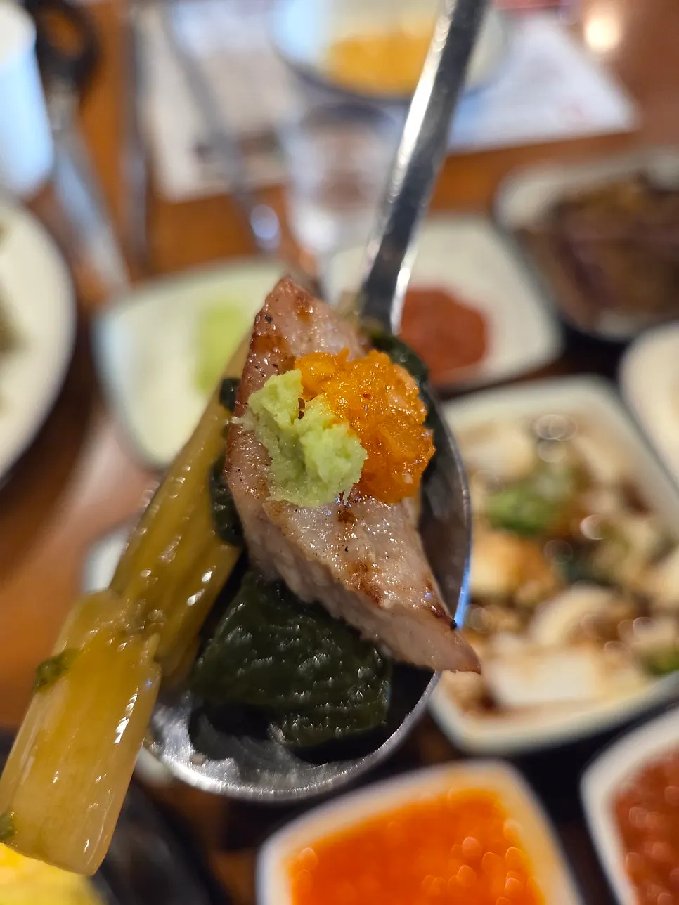 Meat combo topped with mustard leaf pickle and wasabi