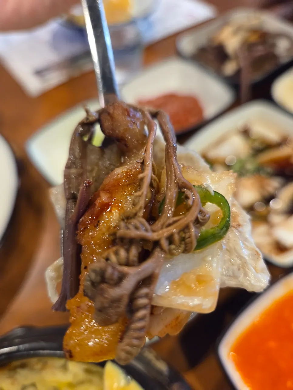 A piece of meat with fermented anchovy sauce and grilled fernbrake