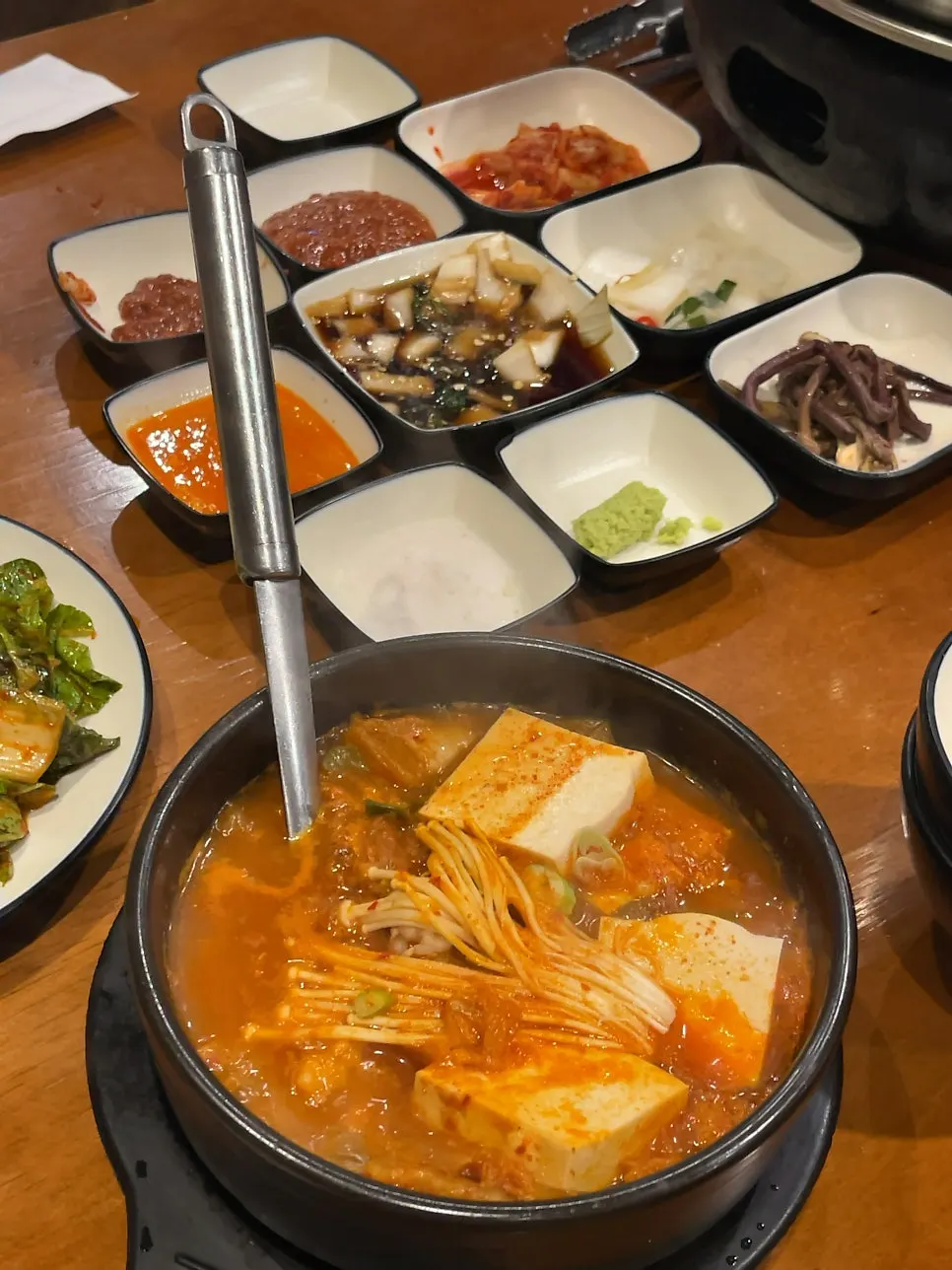 A spoonful of broth and meat from the kimchi jjigae
