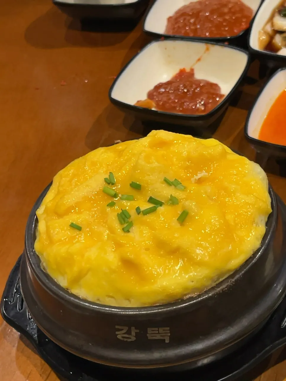 Soft steamed egg split open with a spoon