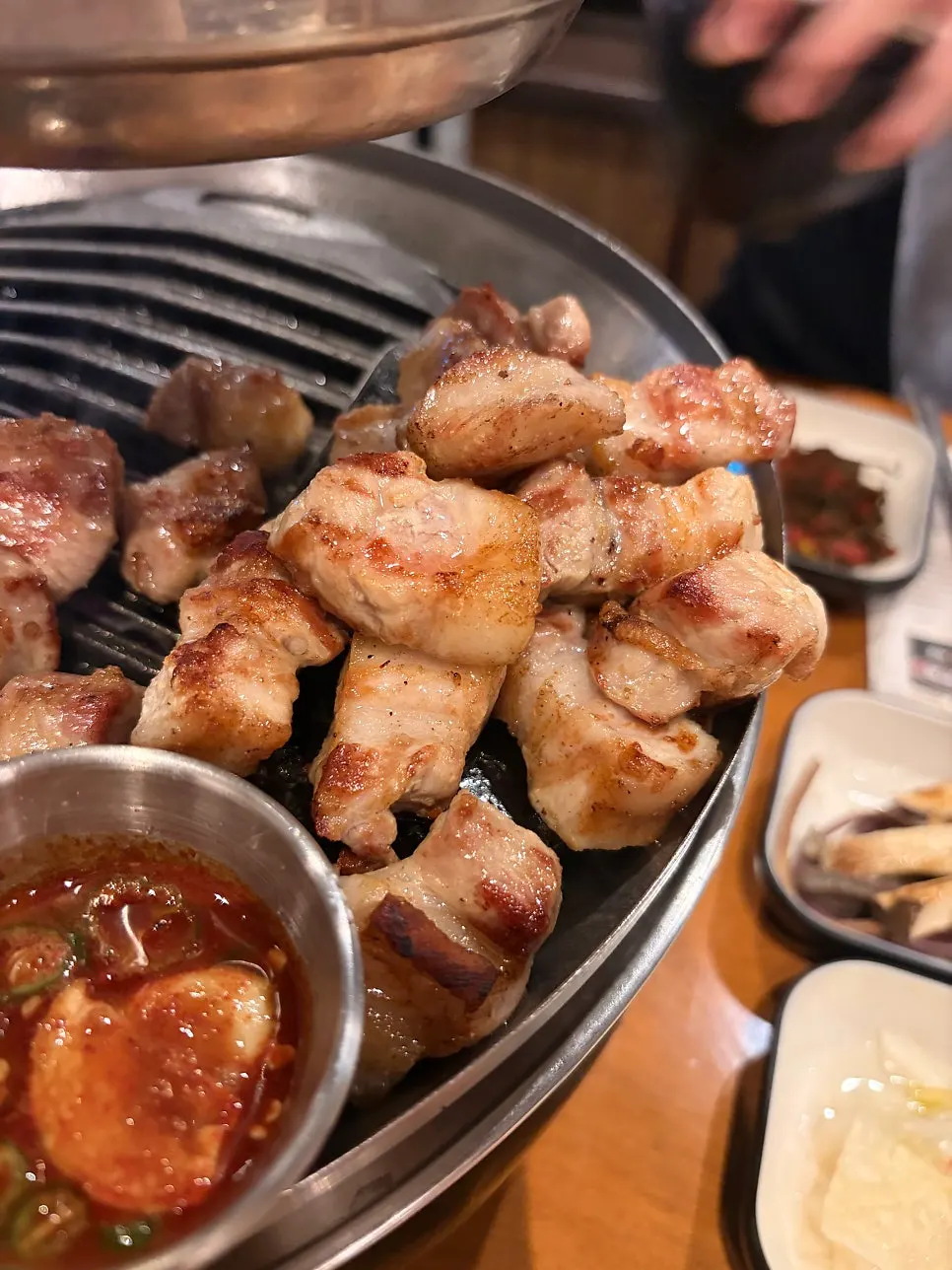 Finished spread of charcoal-grilled meat and side dishes