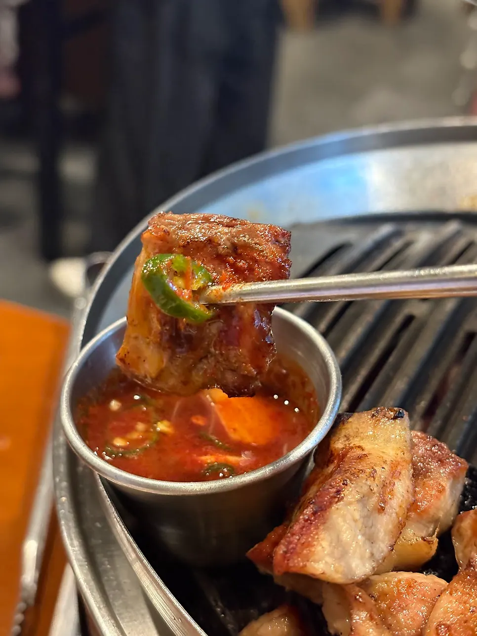 A piece of meat next to myeoljeot sauce