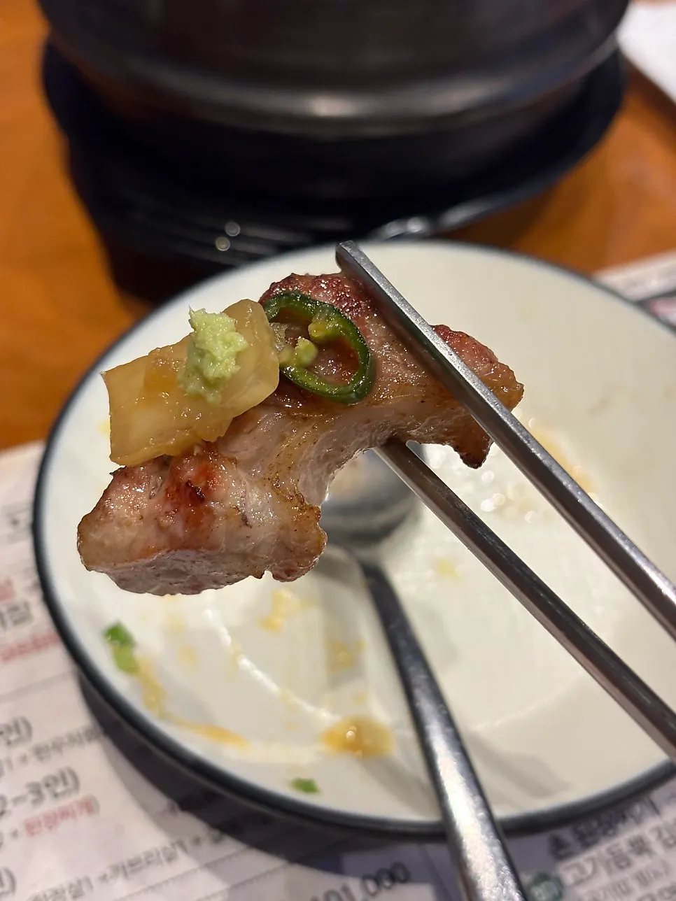 Meat served with pickled onions and scallion kimchi