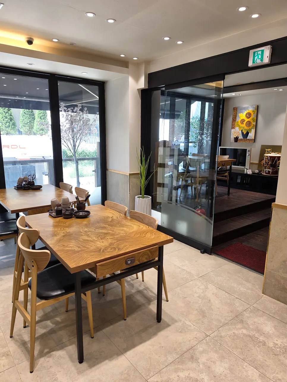 Interior of Geumnyeong Gomtang Yeoksam Branch with wood-toned tables