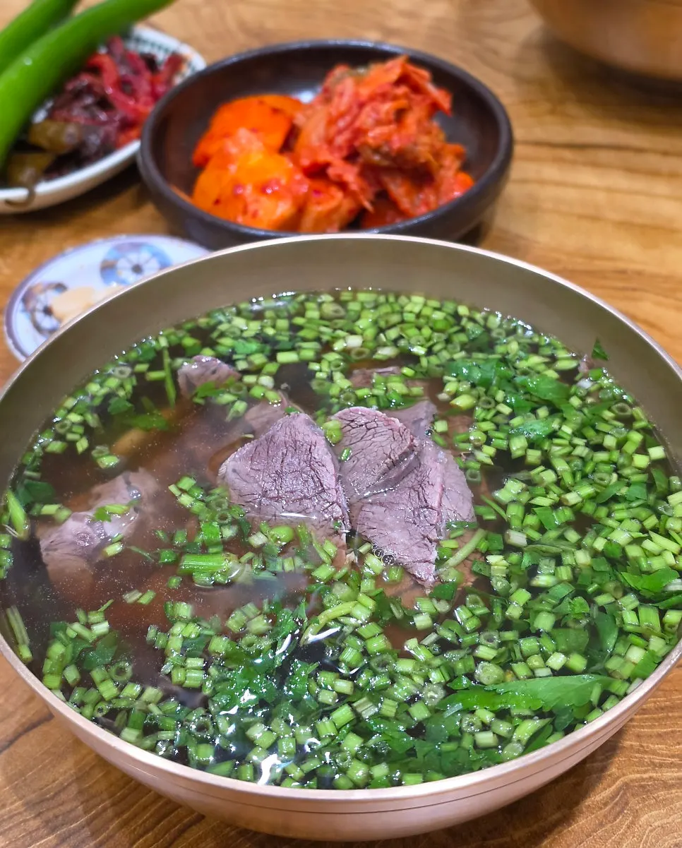 A bowl of minari gomtang special topped with minari