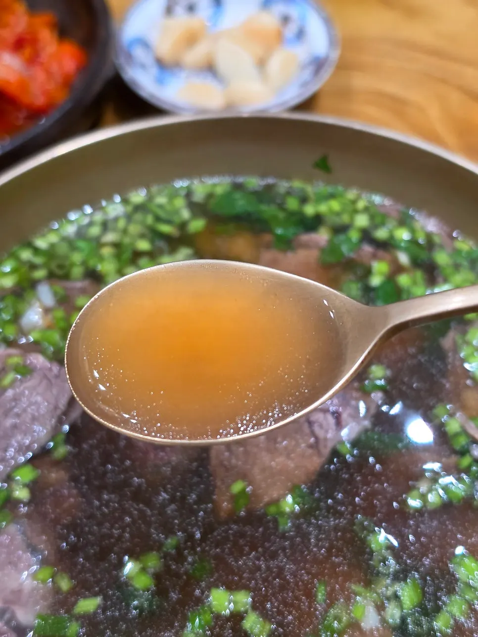 Close-up of minari piled generously on top of the broth