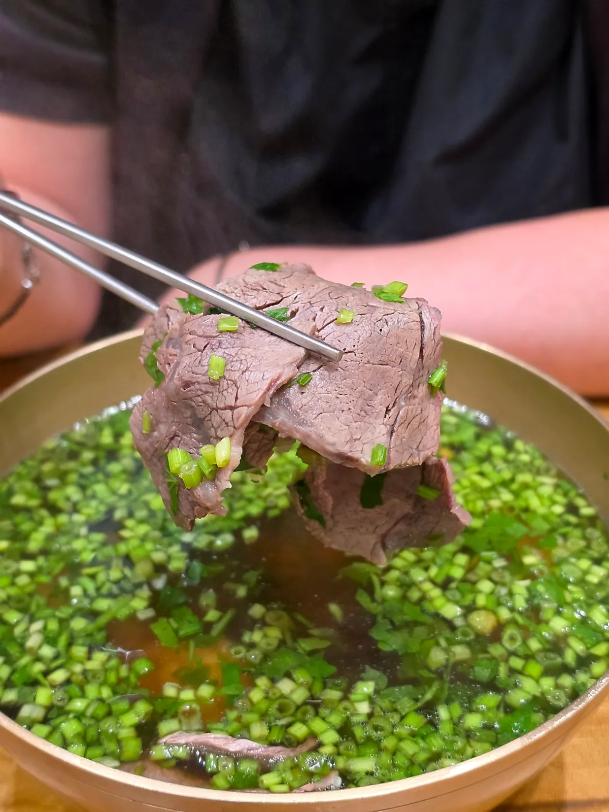 Minari coming up with broth on a spoon