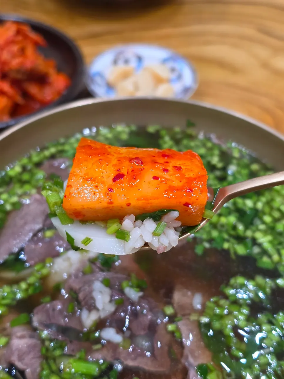 A spoonful of toryeom-style rice and broth