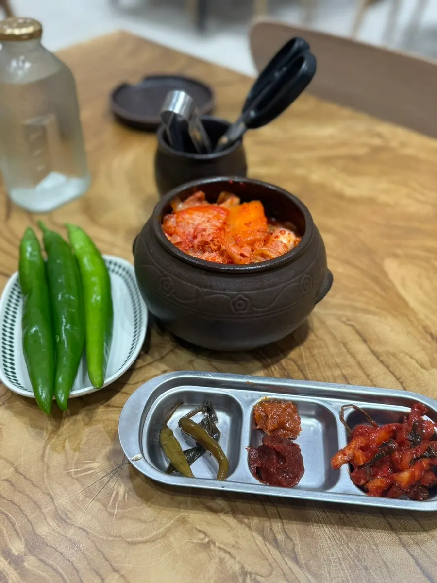 Earthenware jars of kimchi and radish kimchi on the table