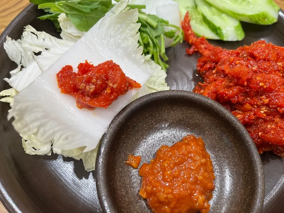 Cabbage and ssamjang served alongside the pollock salad