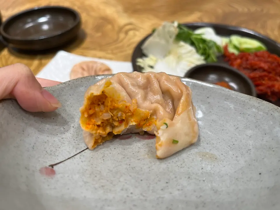 Cross-section of a kimchi dumpling packed with filling
