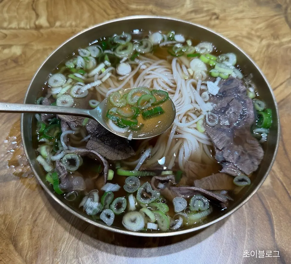 Gomtang-style rice noodles loaded with scallions and meat