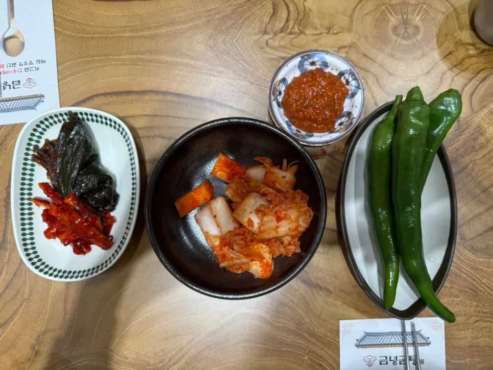 Plate of cucumber peppers and side dishes taken from the self-serve bar