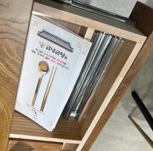 Table drawer holding spoons and chopsticks