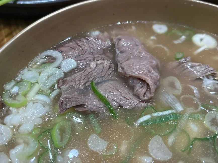Clear gomtang broth loaded with meat