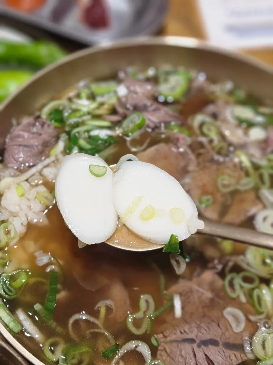 A spoonful of rice topped with soybean paste sesame leaf pickle