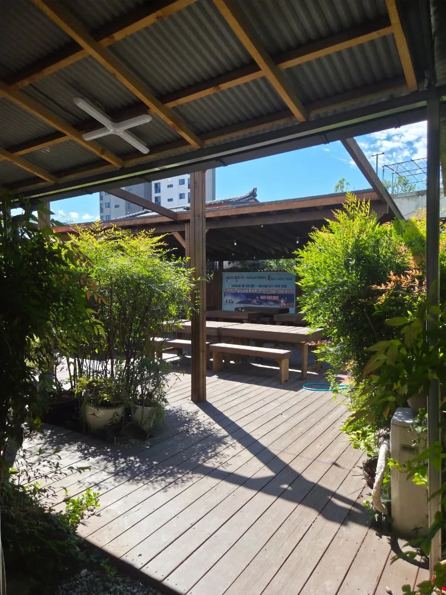 Courtyard with trees and tables at Madang Itneun Jip