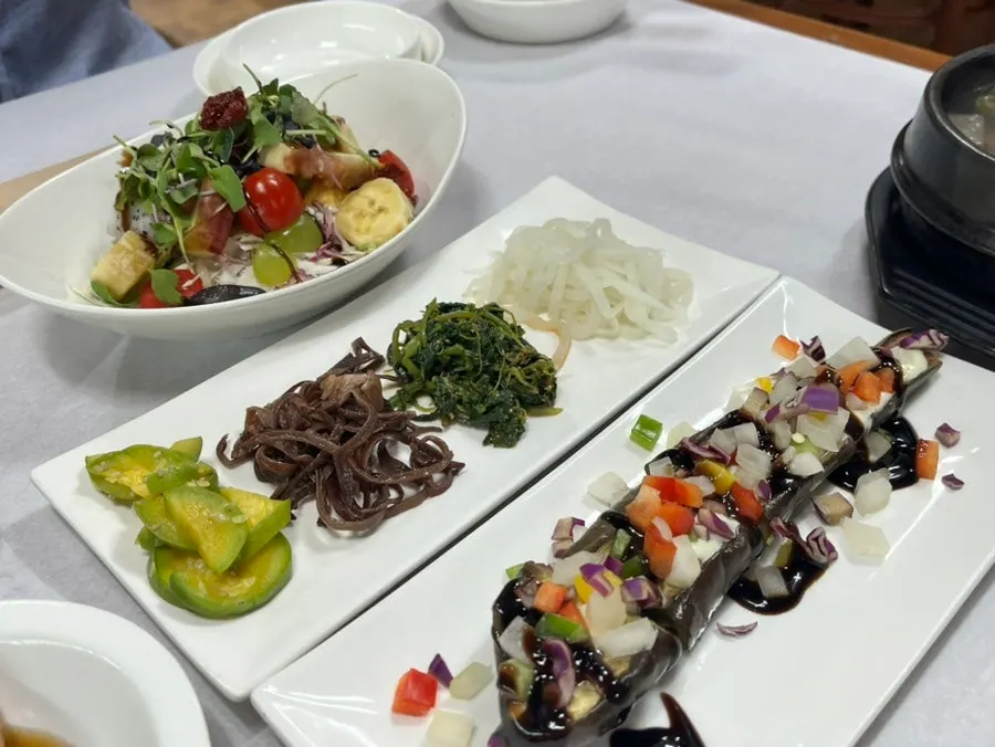 Steamed eggplant topped with bell pepper and namul side dishes