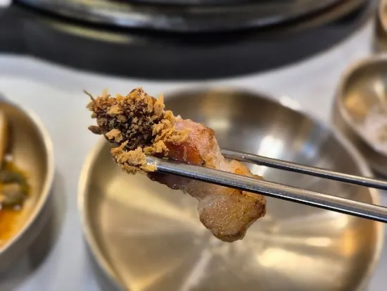 A piece of galbi bonsamgyeop dipped in salt