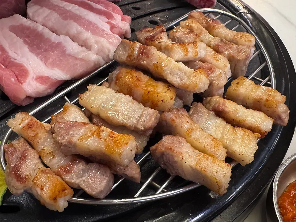Pork turning golden brown on the charcoal grill