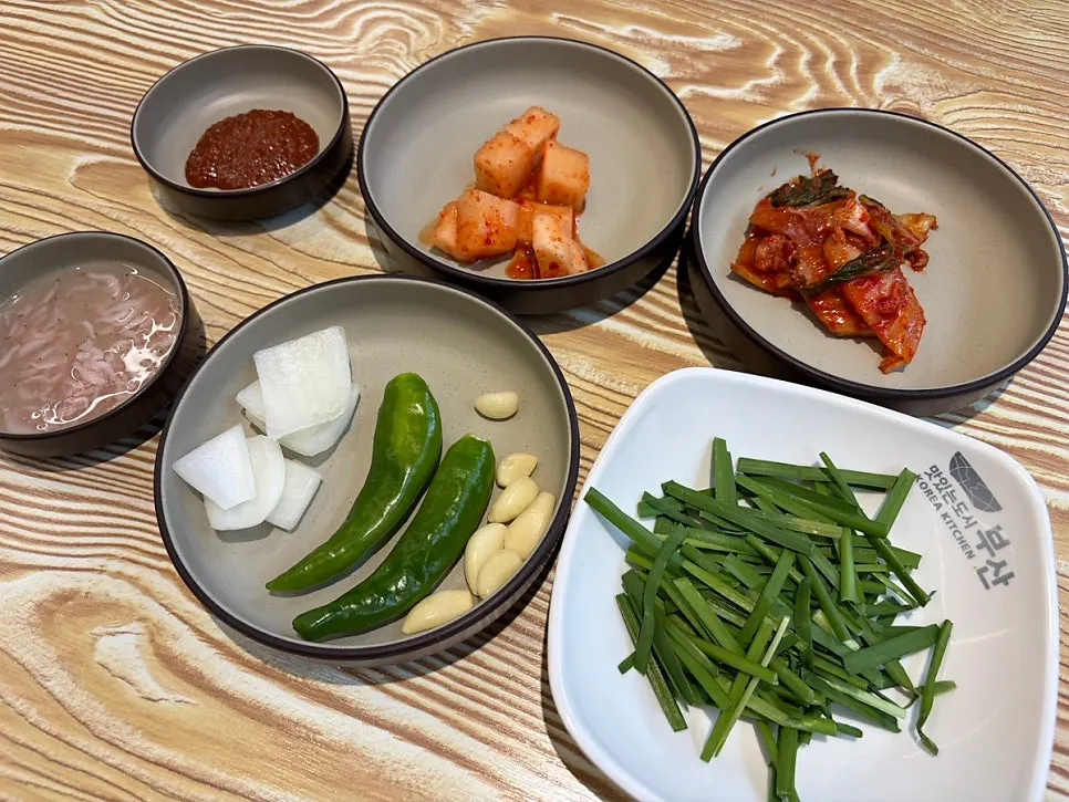 Table setting with kimchi, radish kimchi, and chives