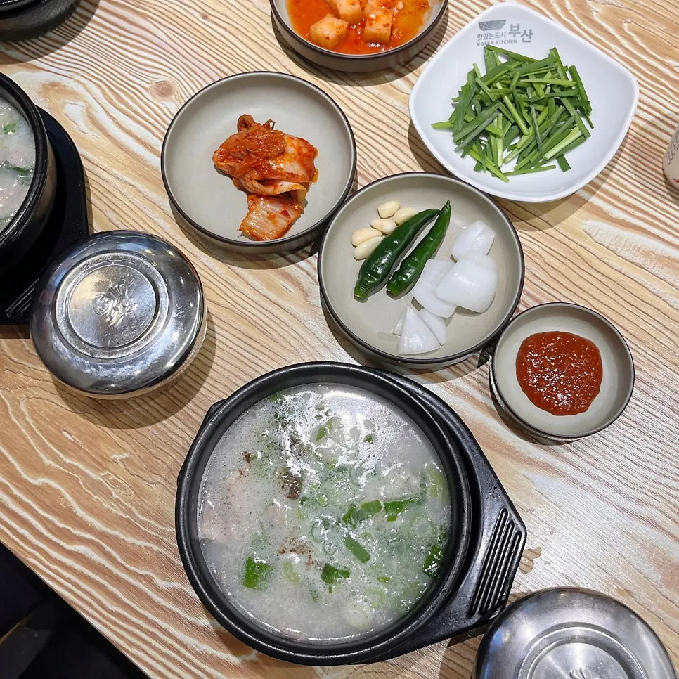 Steaming earthenware bowl of pork gukbap