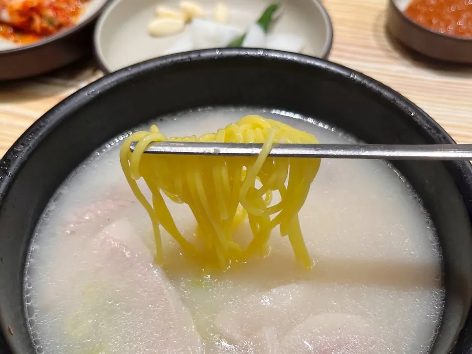 Thin noodles, rice, and kimchi added into the broth