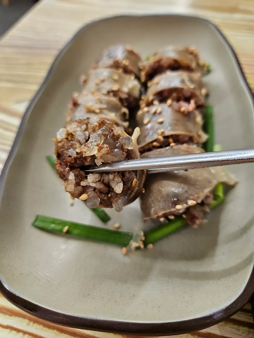 A cup of makgeolli served as a palate cleanser before the gukbap