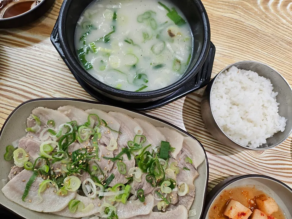 Table set with the boiled pork set and pork jowl gukbap