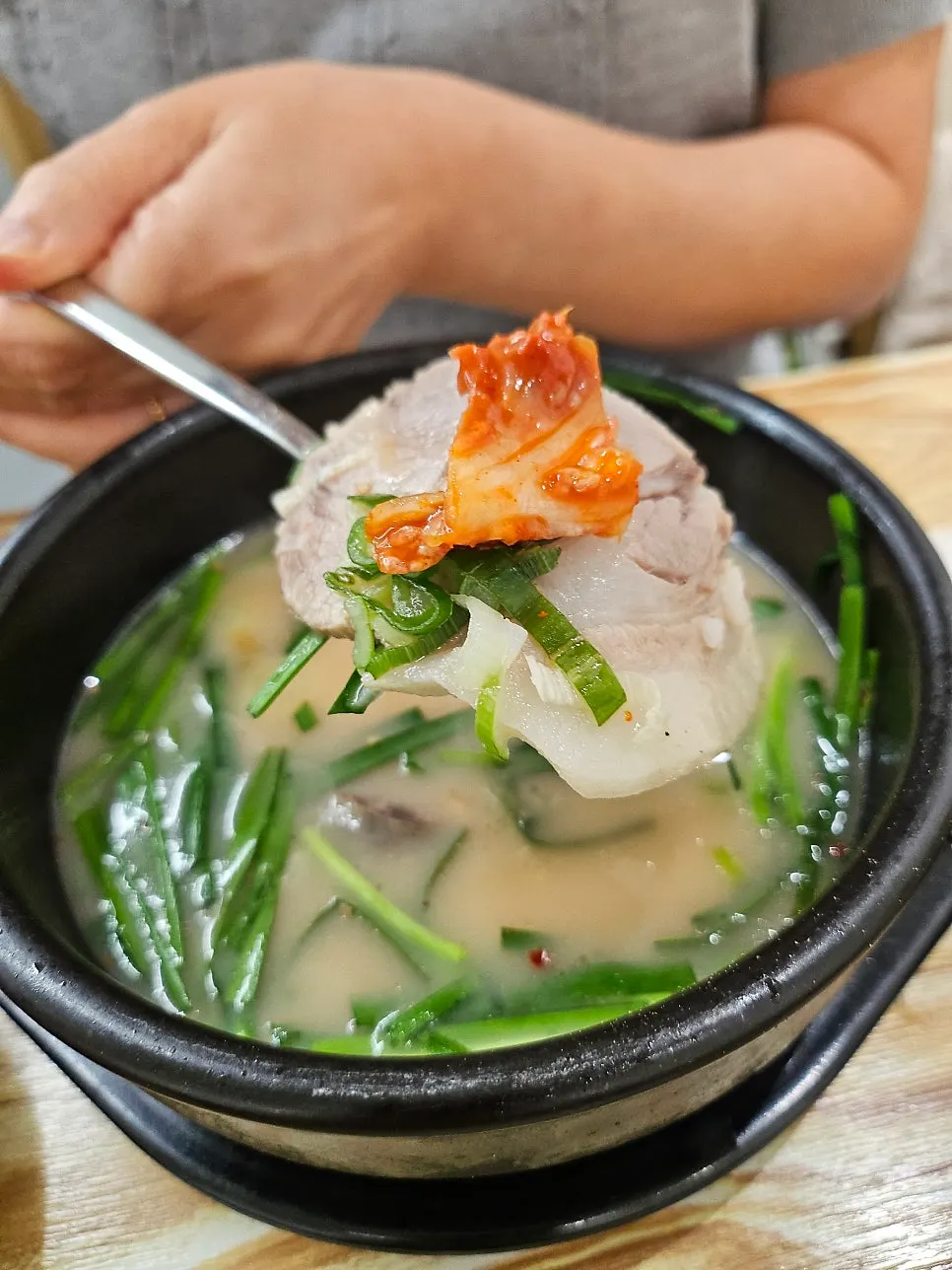 Lifting up a piece of the boiled pork