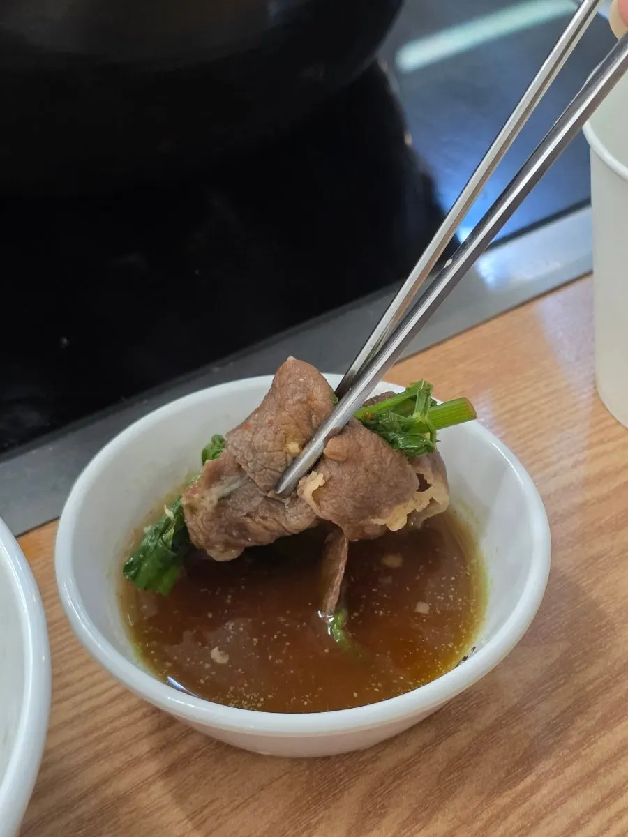 Beef added to the boiling broth