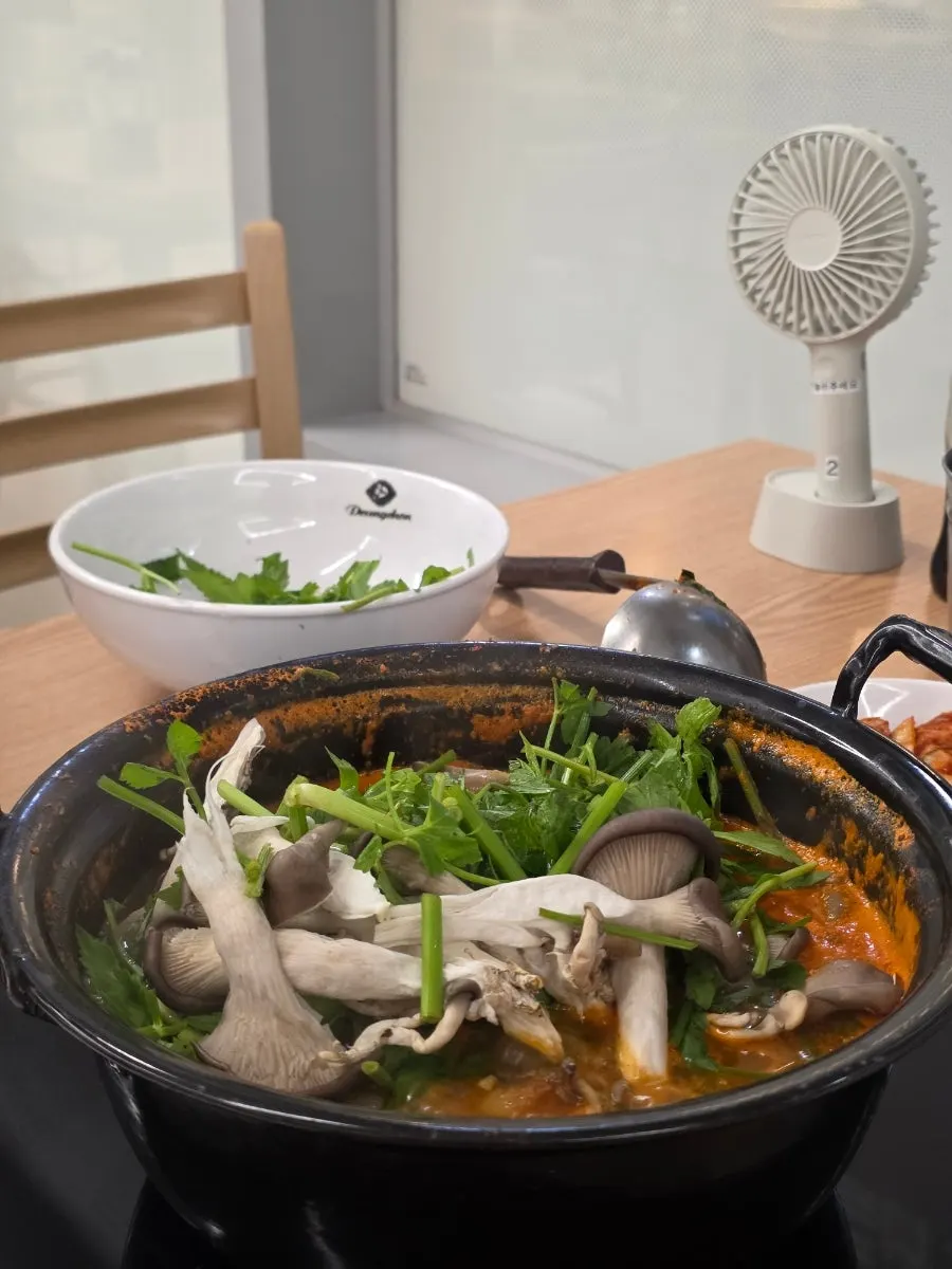Extra minari and mushroom added to the pot