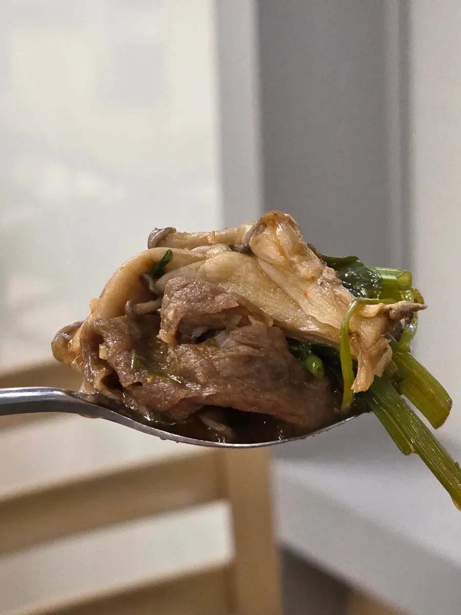 Meat topped with mushroom and minari