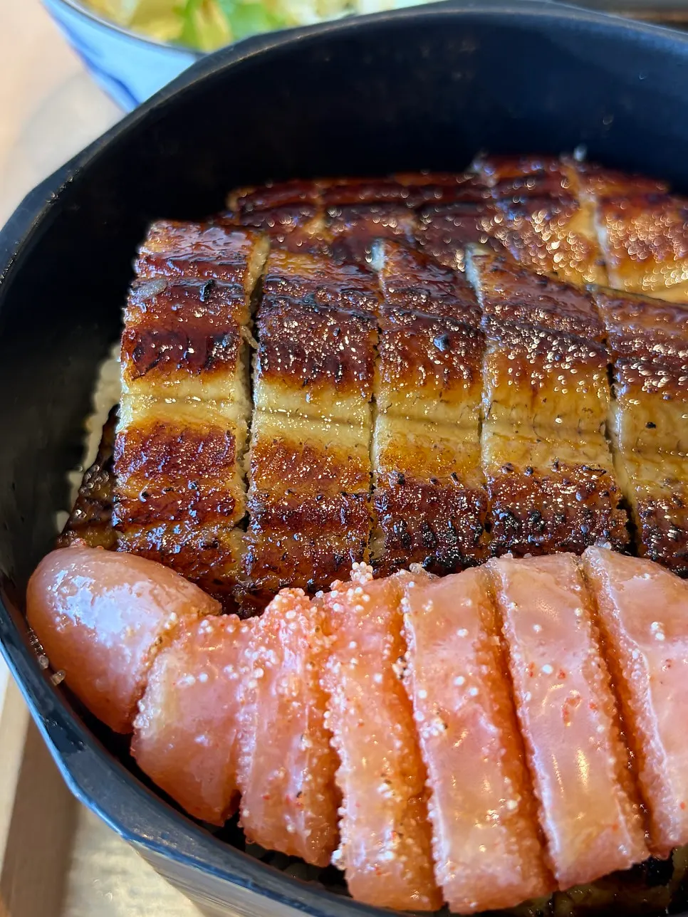 Kimchi served alongside the eel rice bowl