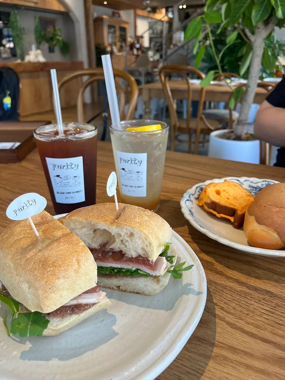 Sandwich and drinks set up at a window seat