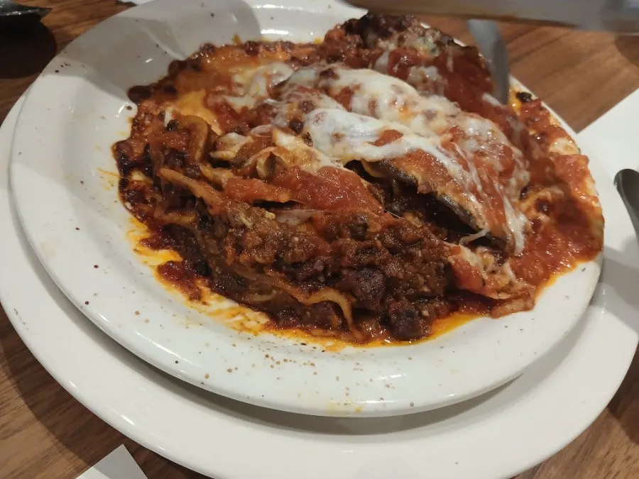 Hot lasagna with a plate underneath