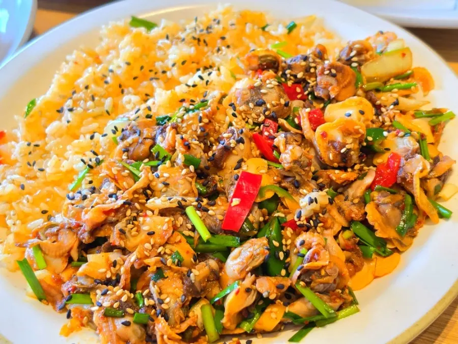 Cockle bibimbap with a full spread of side dishes