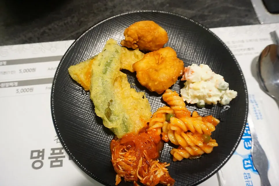 A plate of salad bar food put together for the child