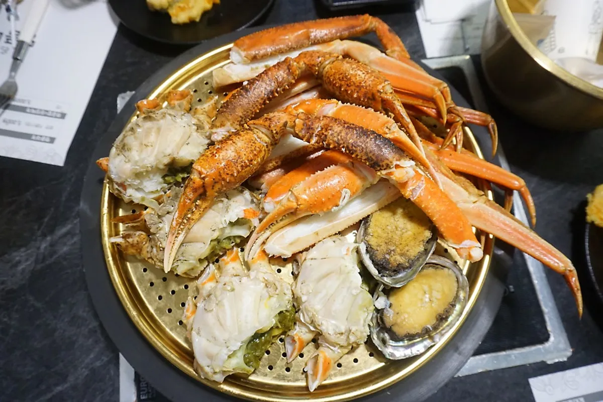 Snow crab and complimentary abalone served on a steamer