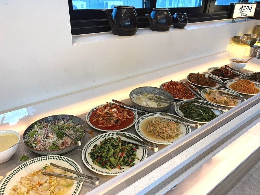 Self-serve corner with side dishes at Dongam Tteokgalbi