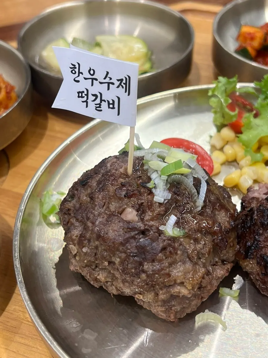 A piece of hanwoo tteokgalbi placed on rice