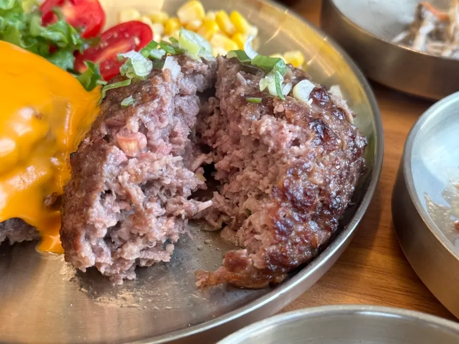 Cross-section of tteokgalbi split in half showing juices