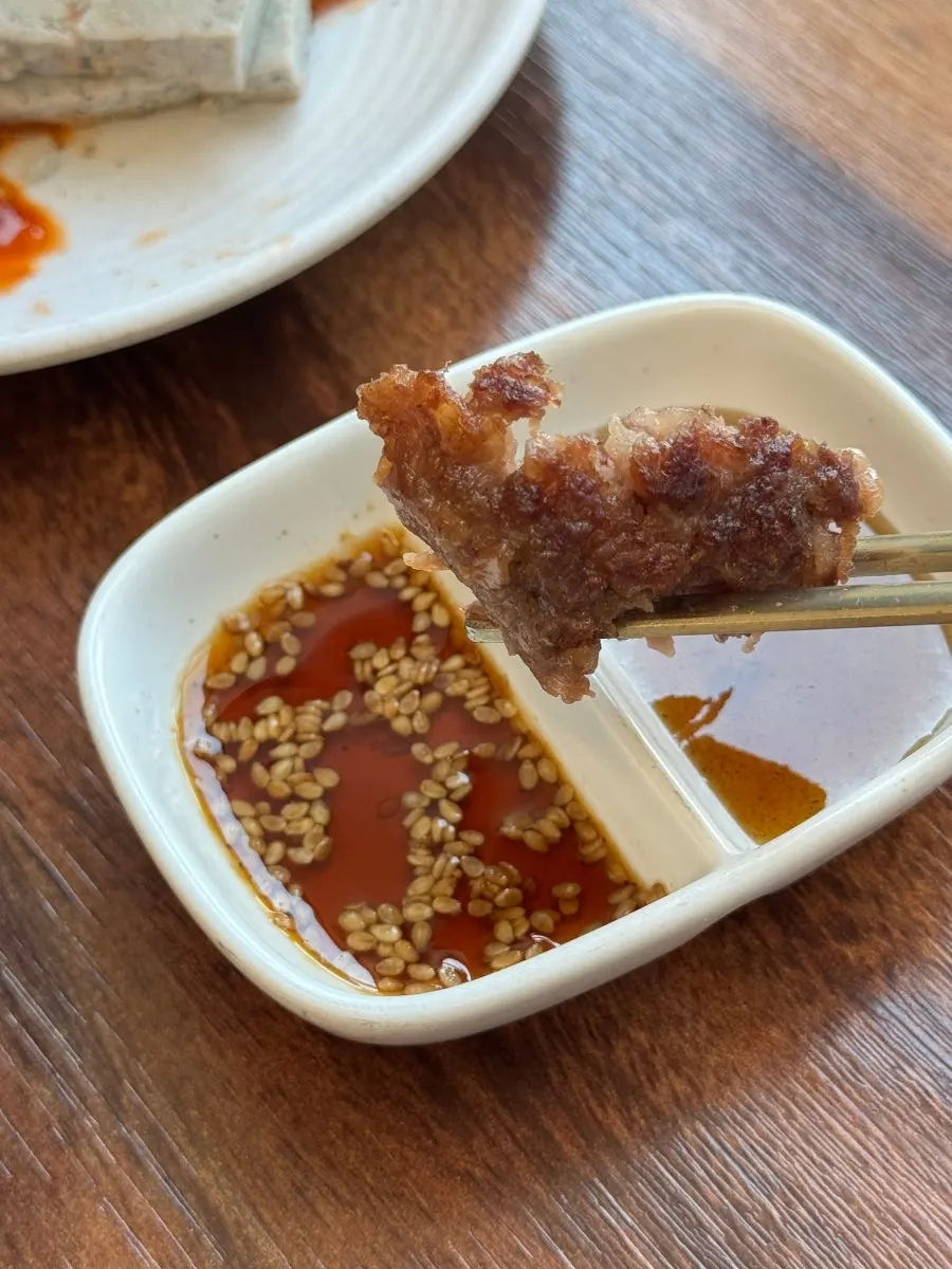 Tteokgalbi dipped in the special soy sauce