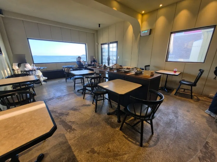 Tables and window seats inside the main building