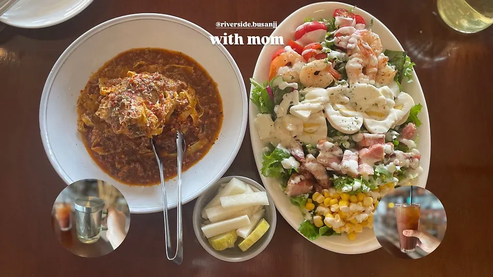 Table with cobb salad and ragu pasta together