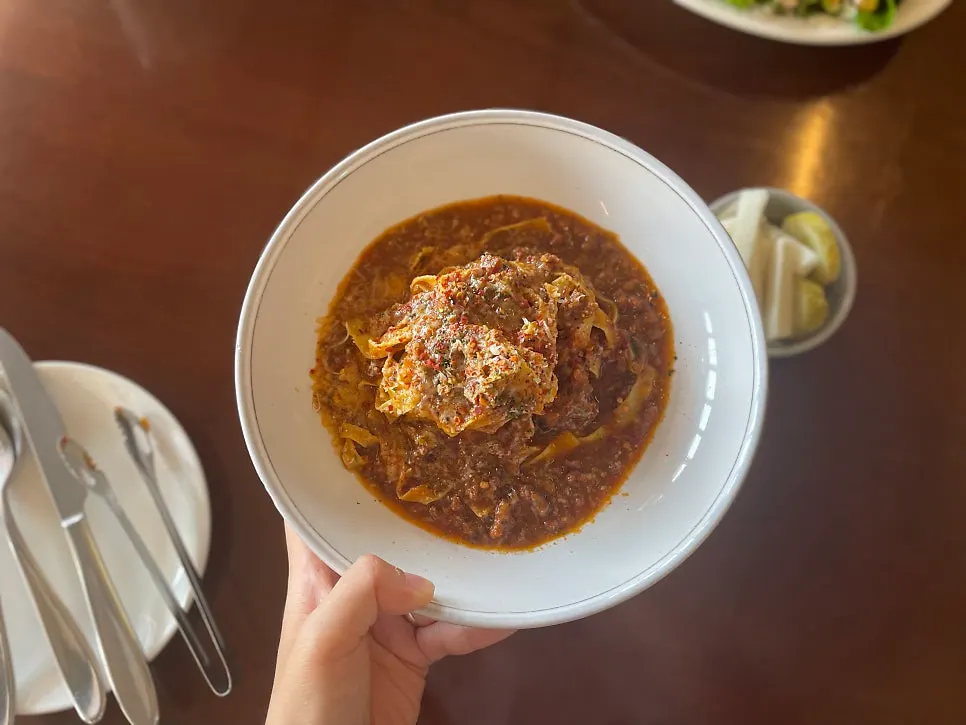 Fresh ragu pasta topped with ragu sauce
